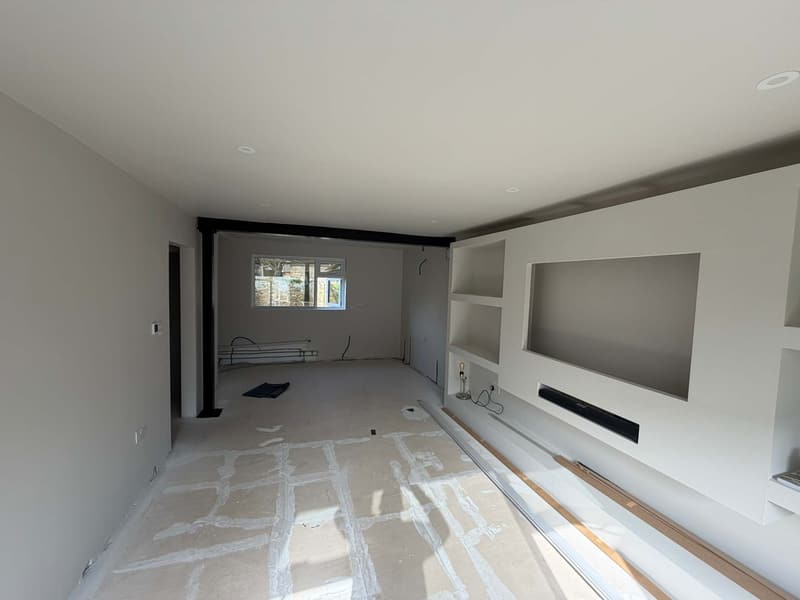 The lounge mid-job, with walls made good, the media wall recess formed and the floor protected